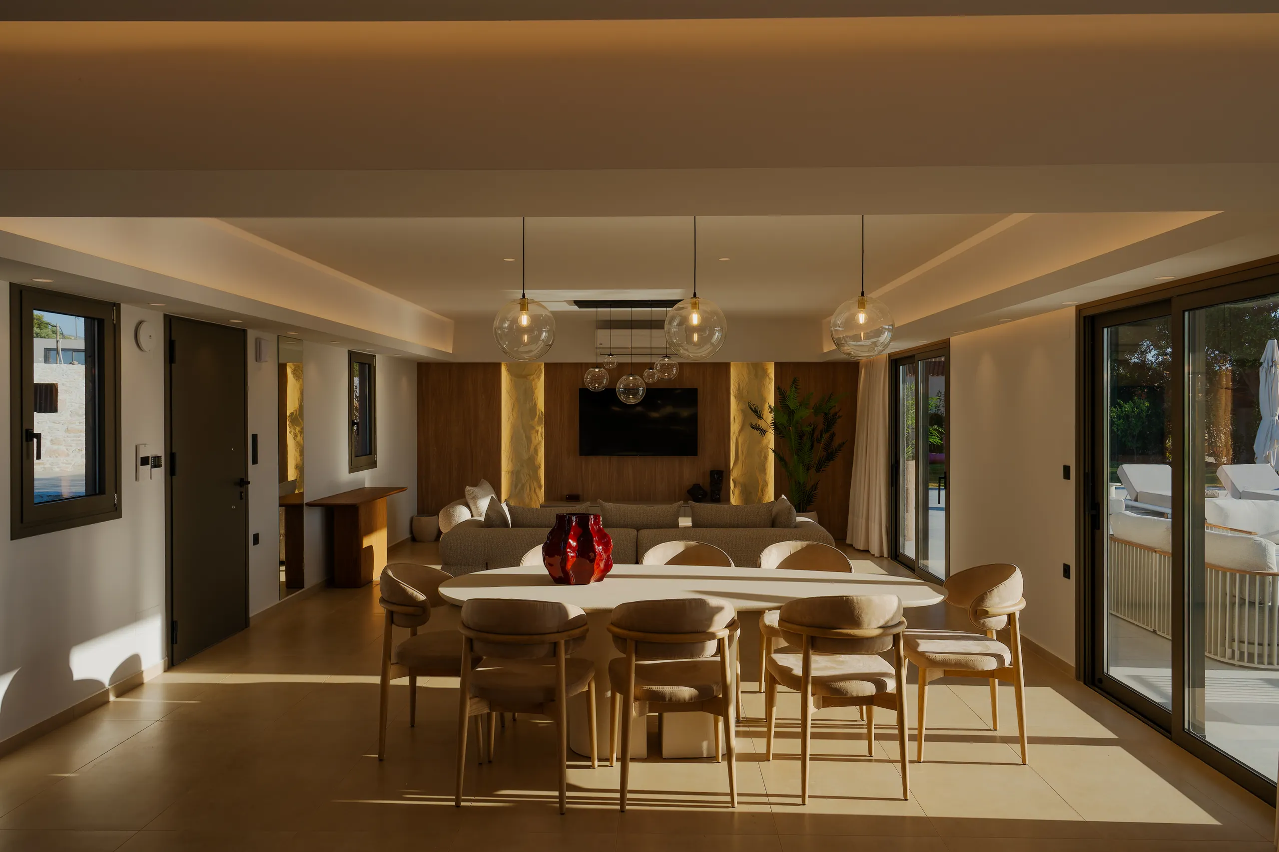 Left Crete's open-plan dining and living room in warm evening light